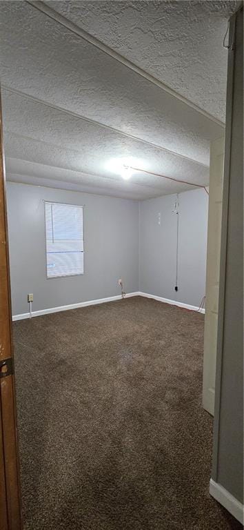 carpeted spare room featuring a textured ceiling