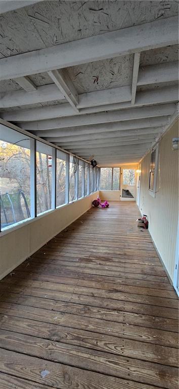 unfurnished sunroom featuring plenty of natural light