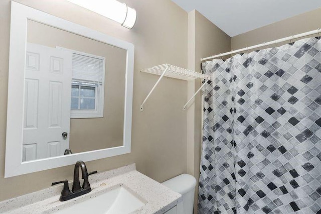 bathroom featuring vanity and toilet