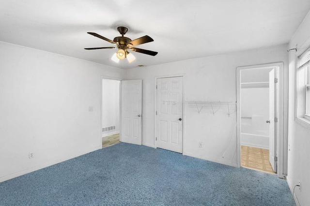 unfurnished bedroom featuring carpet flooring, connected bathroom, and ceiling fan