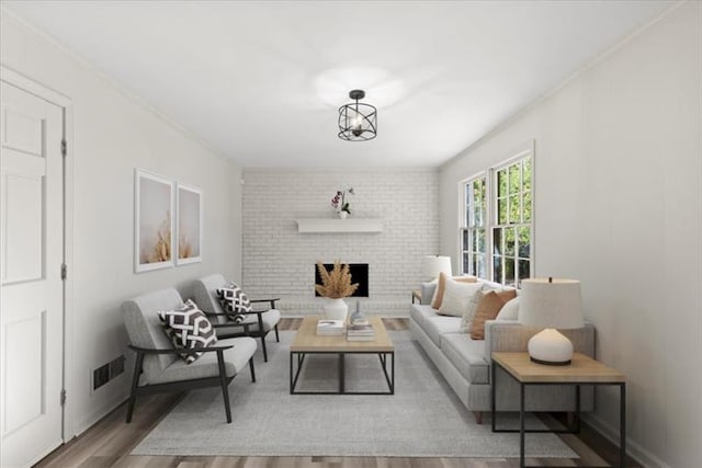 living room featuring ornamental molding, wood-type flooring, and a brick fireplace