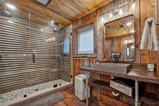 bathroom featuring wood-type flooring, an enclosed shower, wooden walls, vanity, and wood ceiling