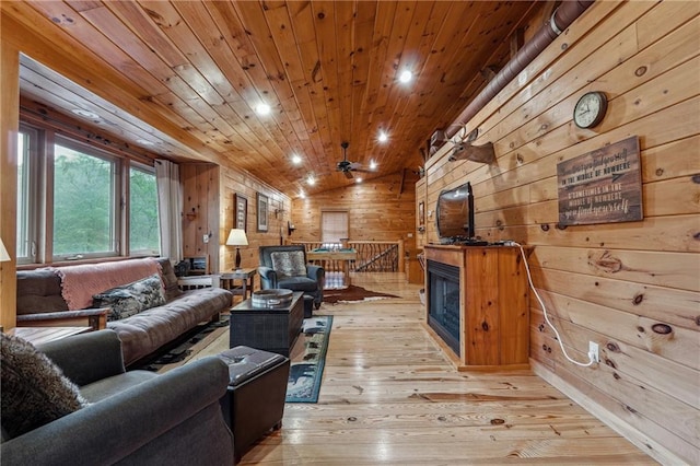 living room featuring light hardwood / wood-style floors, wood ceiling, lofted ceiling, and wood walls