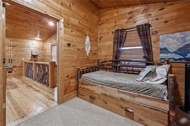 carpeted bedroom featuring wood walls, lofted ceiling, and wooden ceiling