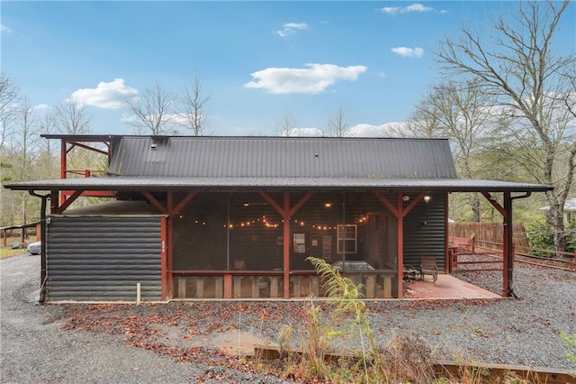 back of property with a patio area and a sunroom