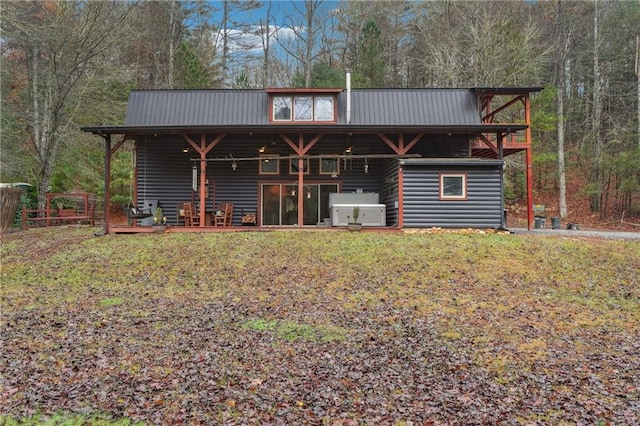 rear view of property with a lawn