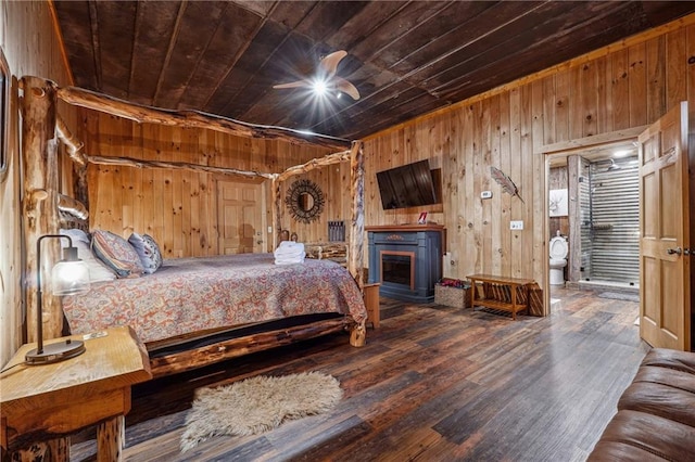 bedroom featuring wood-type flooring, a fireplace, wooden walls, and wooden ceiling