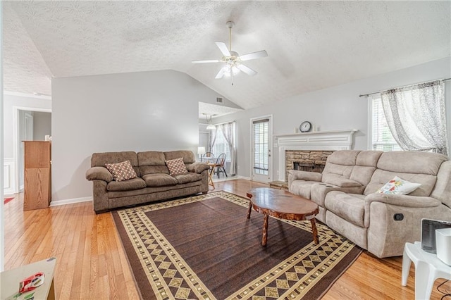 901 Elijah Way, Bethlehem, GA 30620 - living area featuring ceiling fan, light wood-style floors, lofted ceiling, a textured ceiling, and a fireplace