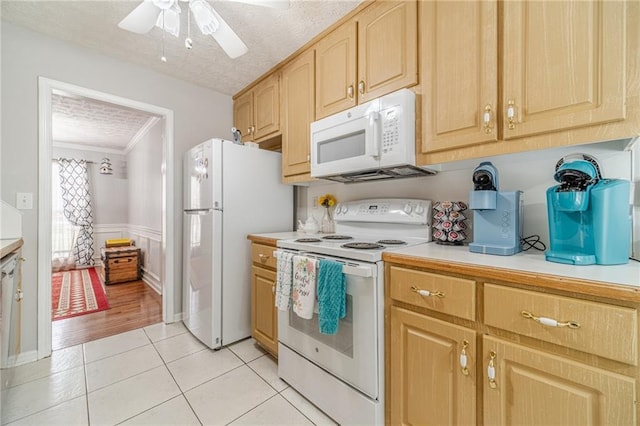 901 Elijah Way, Bethlehem, GA 30620 - kitchen featuring white appliances, light countertops, light brown cabinets, light tile patterned flooring, and a wainscoted wall
