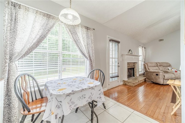 901 Elijah Way, Bethlehem, GA 30620 - tiled dining area with vaulted ceiling and a stone fireplace