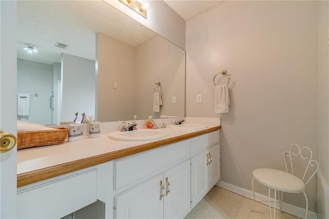 901 Elijah Way, Bethlehem, GA 30620 - bathroom featuring double vanity, baseboards, and a textured ceiling