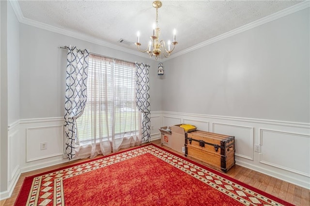 901 Elijah Way, Bethlehem, GA 30620 - spare room featuring a chandelier, wood finished floors, wainscoting, ornamental molding, and a textured ceiling