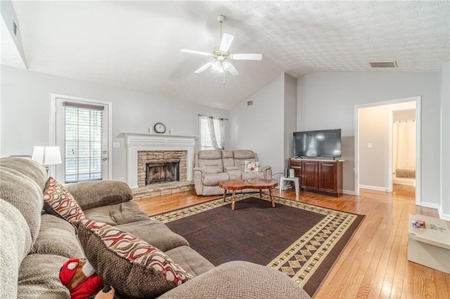 901 Elijah Way, Bethlehem, GA 30620 - living room with light wood-style flooring, vaulted ceiling, a ceiling fan, a fireplace, and baseboards