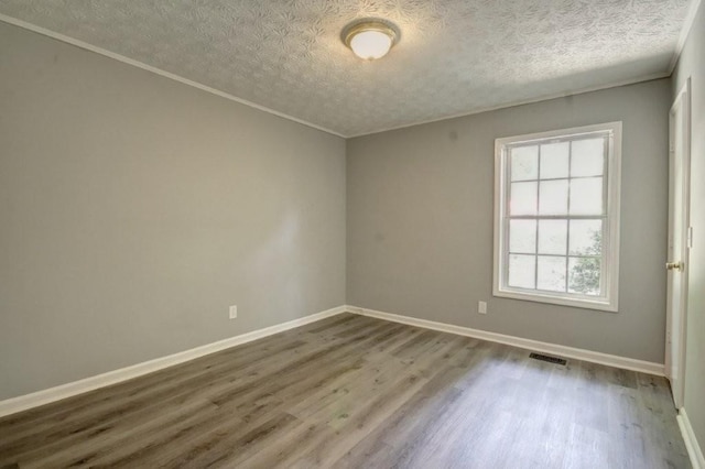 2773 Hawk Trace Ct NE, Marietta, GA 30066 - empty room featuring wood finished floors, a textured ceiling, and ornamental molding