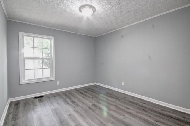 2773 Hawk Trace Ct NE, Marietta, GA 30066 - spare room featuring a textured ceiling, wood finished floors, and crown molding