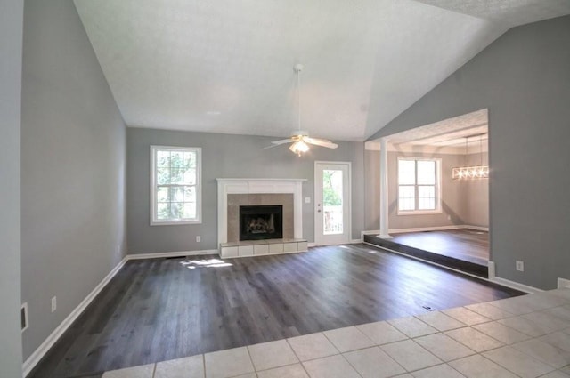 2773 Hawk Trace Ct NE, Marietta, GA 30066 - unfurnished living room with vaulted ceiling, healthy amount of natural light, tile patterned floors, a fireplace, and a ceiling fan