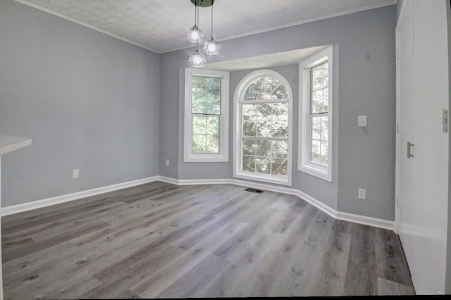 2773 Hawk Trace Ct NE, Marietta, GA 30066 - unfurnished dining area featuring ornamental molding, wood finished floors, and a textured ceiling