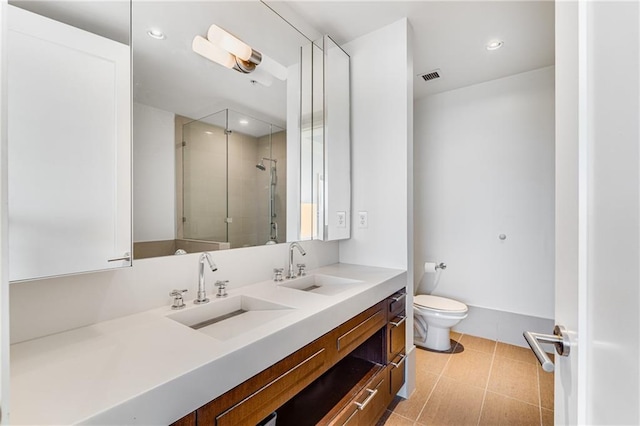 bathroom featuring toilet, an enclosed shower, vanity, and tile patterned flooring