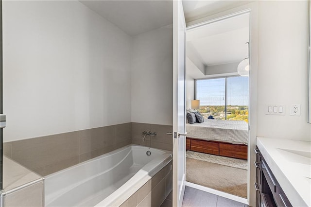 bathroom featuring vanity, tiled bath, and tile patterned flooring