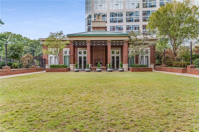 exterior space with a yard and french doors