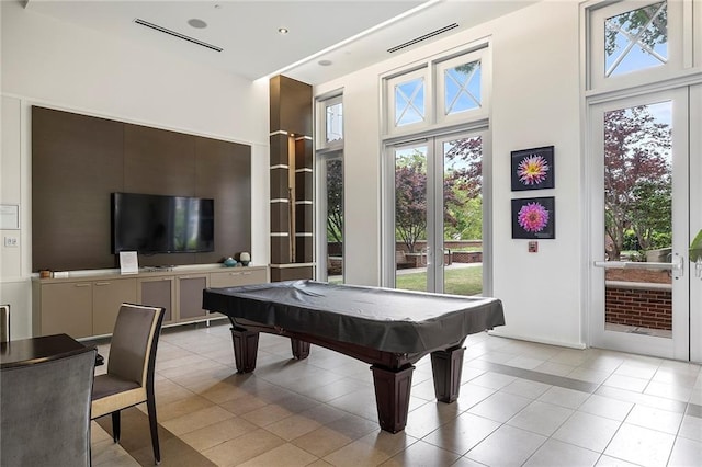 rec room with french doors, light tile patterned floors, billiards, and a towering ceiling