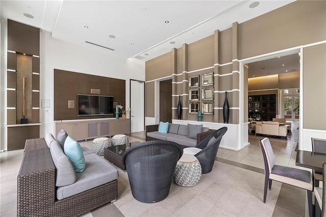 tiled living room with a high ceiling