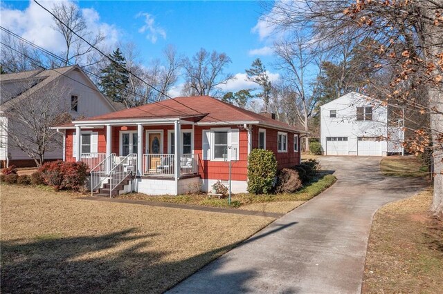 bungalow-style home with covered porch and a front lawn