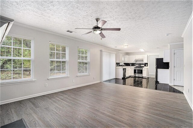 unfurnished living room with ornamental molding, ceiling fan, dark hardwood / wood-style floors, and a textured ceiling