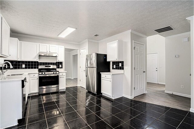 kitchen with white cabinetry and appliances with stainless steel finishes