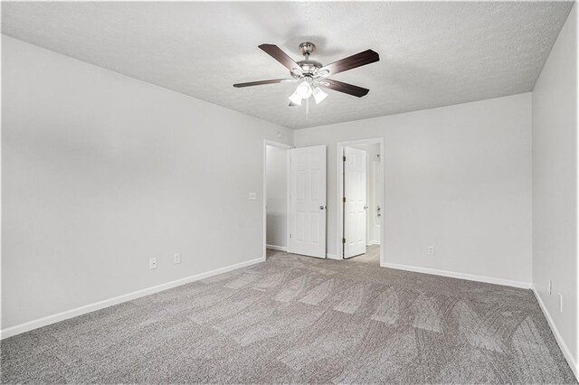 unfurnished bedroom featuring carpet, ceiling fan, and a textured ceiling