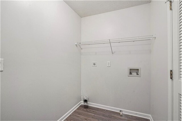 laundry area featuring washer hookup, hookup for an electric dryer, a textured ceiling, and dark hardwood / wood-style floors