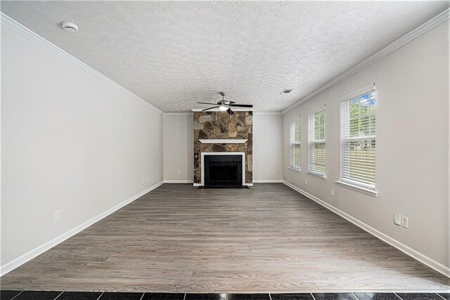 unfurnished living room with wood-type flooring, a fireplace, ornamental molding, and ceiling fan