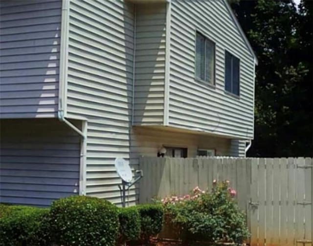 view of home's exterior with fence