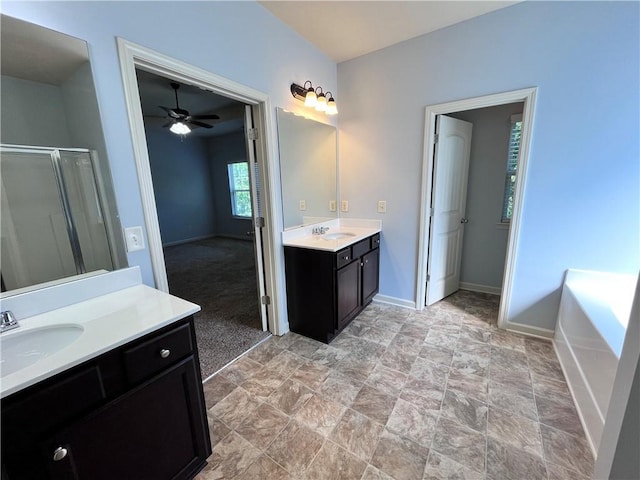 bathroom featuring ceiling fan, separate shower and tub, and vanity