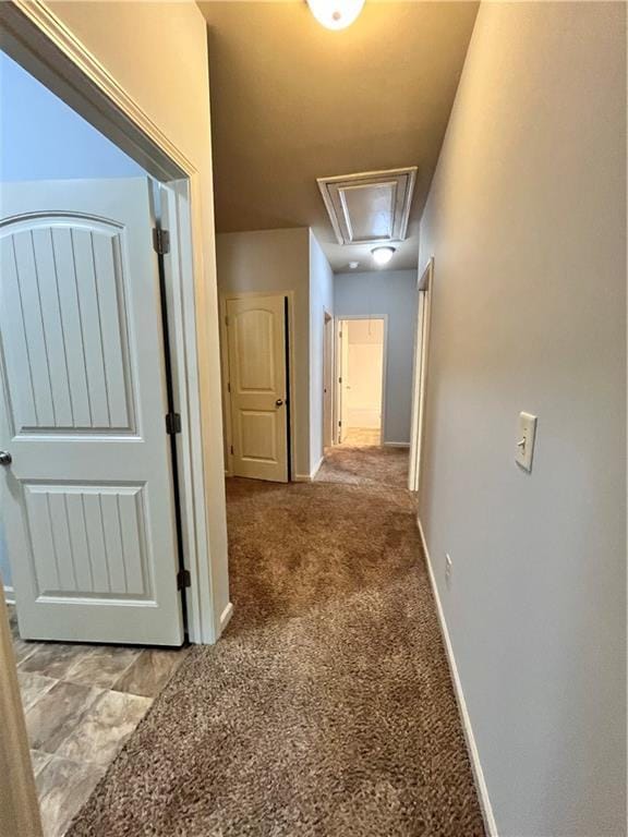 corridor featuring light colored carpet