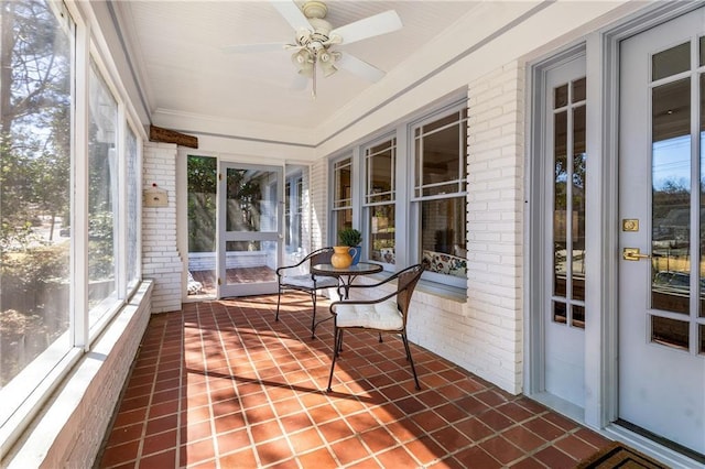 sunroom featuring ceiling fan