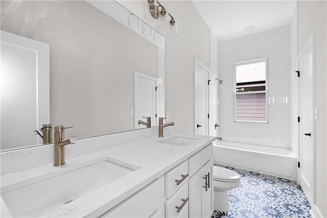 full bathroom featuring toilet, vanity, tile patterned floors, and tiled shower / bath