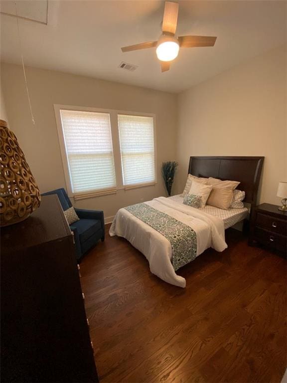 bedroom with dark wood-type flooring and ceiling fan