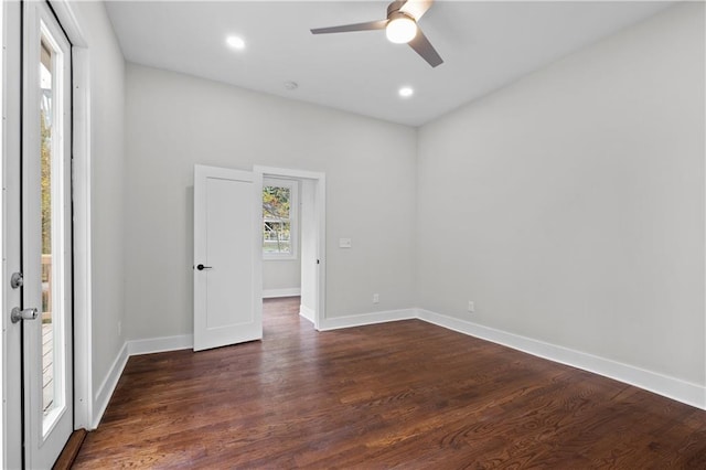 spare room with ceiling fan and dark hardwood / wood-style floors