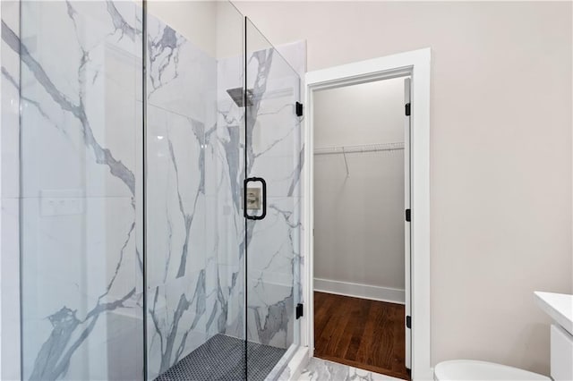 bathroom featuring a shower with shower door and vanity