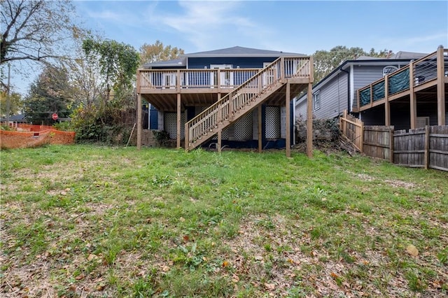 rear view of property with a deck and a lawn