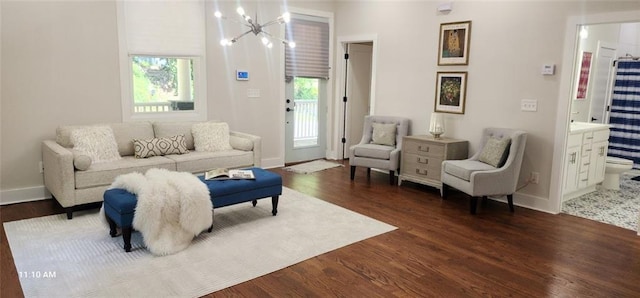 living room featuring dark wood-type flooring and a notable chandelier