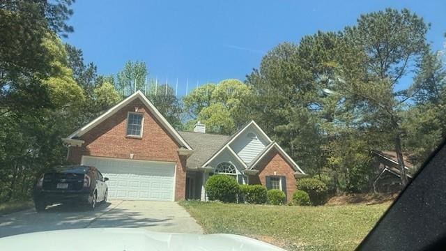 3510 Hog Mountain Rd, Dacula, GA 30019 - view of front of property featuring concrete driveway, brick siding, and a front lawn