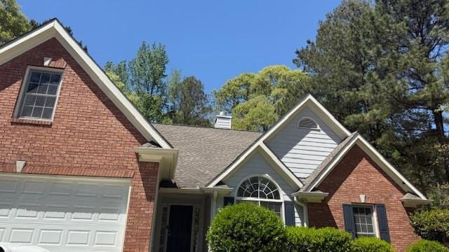 3510 Hog Mountain Rd, Dacula, GA 30019 - traditional-style home with brick siding and a chimney