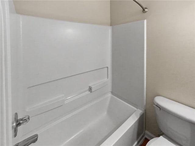 bathroom featuring toilet and bathing tub / shower combination