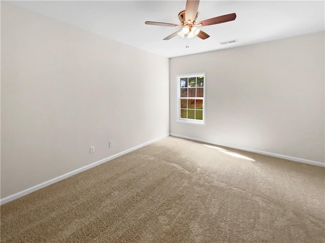 carpeted spare room with ceiling fan