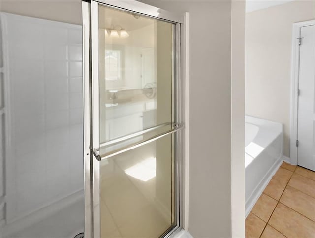 bathroom featuring separate shower and tub and tile patterned floors