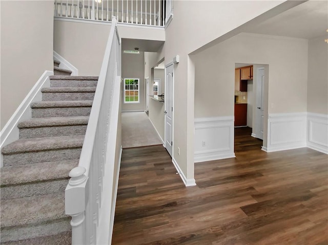 stairs featuring hardwood / wood-style floors