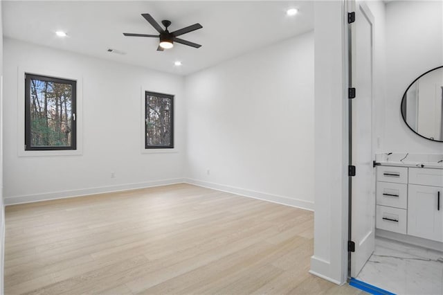 unfurnished room featuring ceiling fan and light hardwood / wood-style flooring