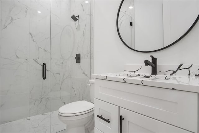 bathroom with toilet, vanity, and an enclosed shower